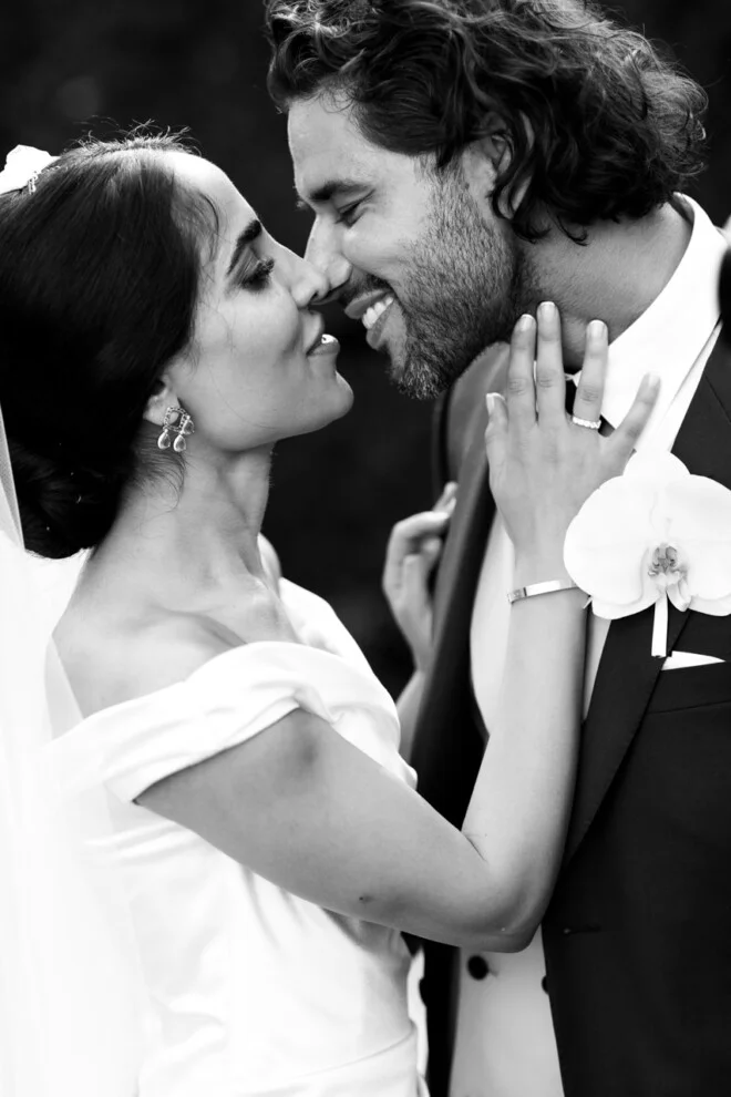 Bride and groom sharing a romantic kiss during their wedding at Villa Grabau in Lucca, Tuscany.