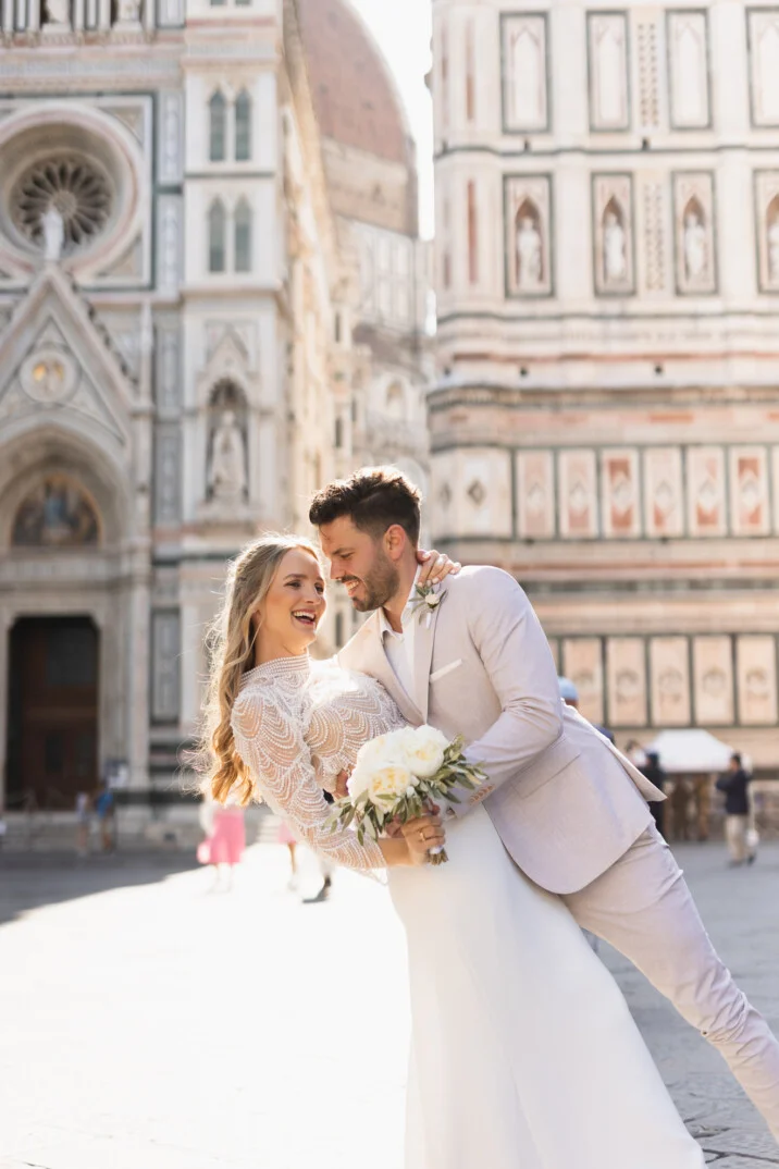 Bride and groom at the Duomo in Florence – Vanni Frassoni Wedding Photography Bride and groom smiling in front of the Florence Cathedral during their wedding
