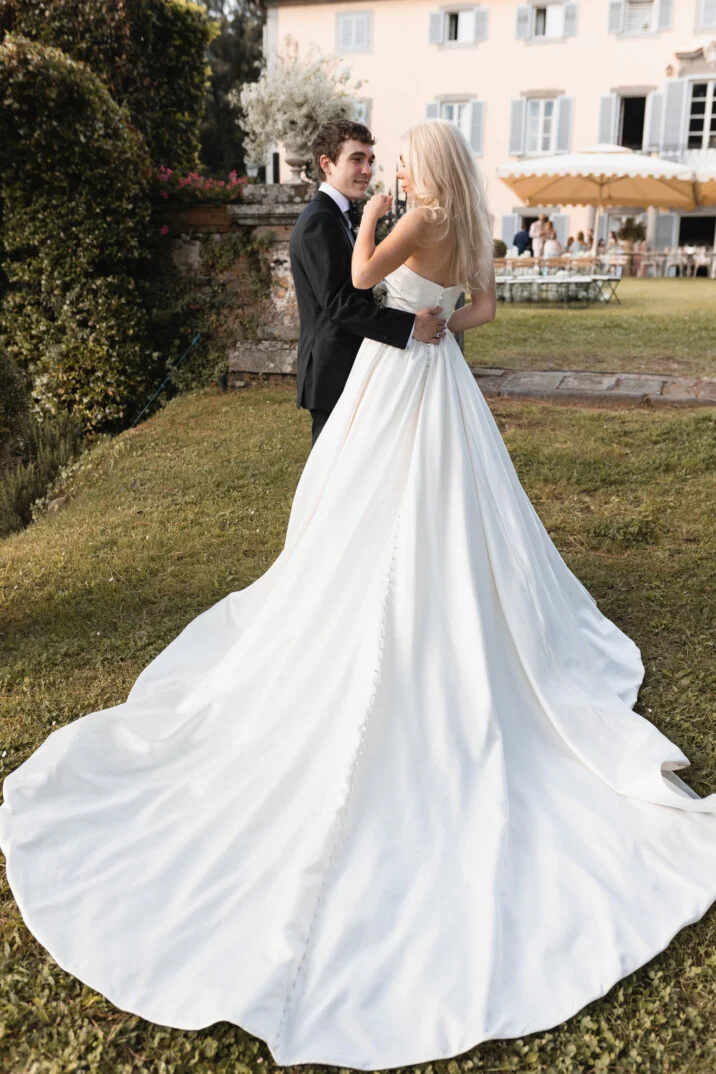 Bride and groom dancing in front of a Tuscan villa in Florence A bride and groom share a romantic moment at their wedding in a garden villa in Florence, Tuscany