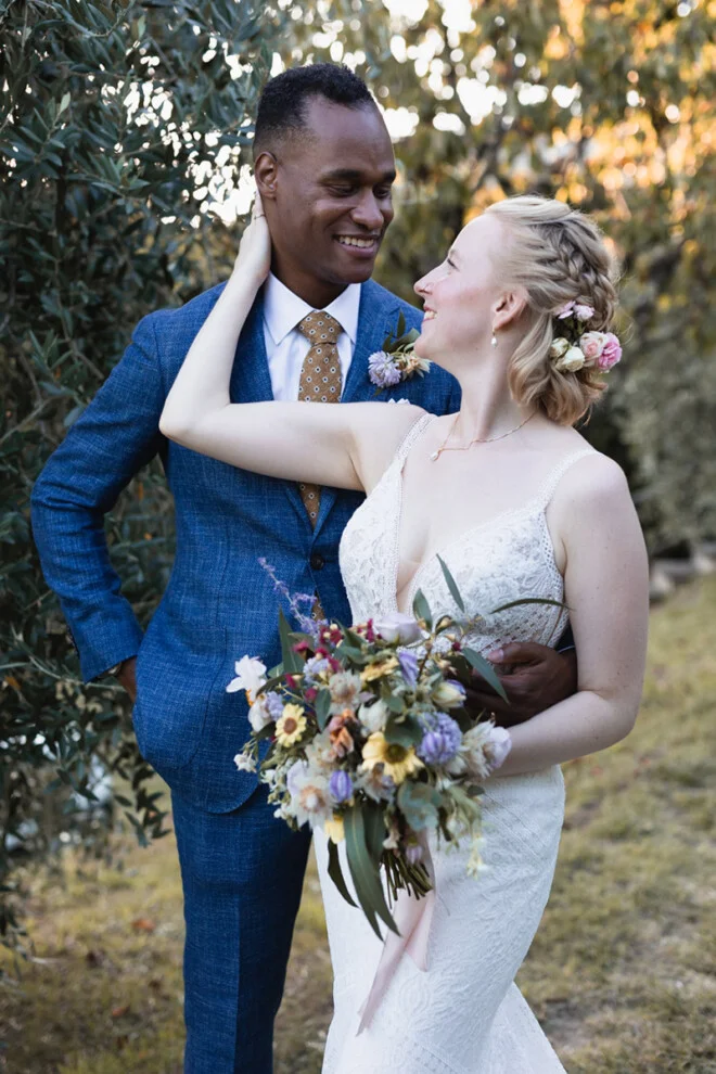 Bride and groom smiling and embracing during their wedding in Garfagnana, Tuscany.