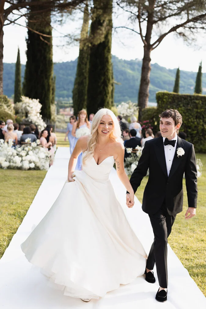 Luxury wedding at Villa Boccella in Tuscany – bride and groom walking after the ceremony, captured by wedding photographer Vanni Frassoni