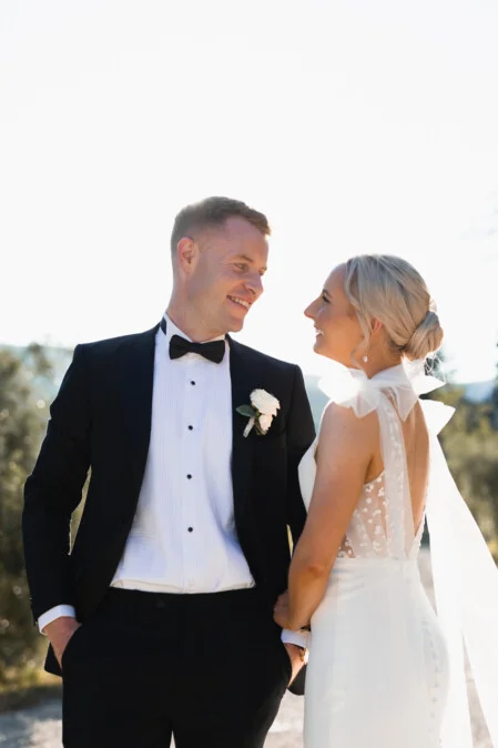 Elegant wedding portrait in Tuscany – bride and groom looking at each other during their destination wedding, photographed by Vanni Frassoni